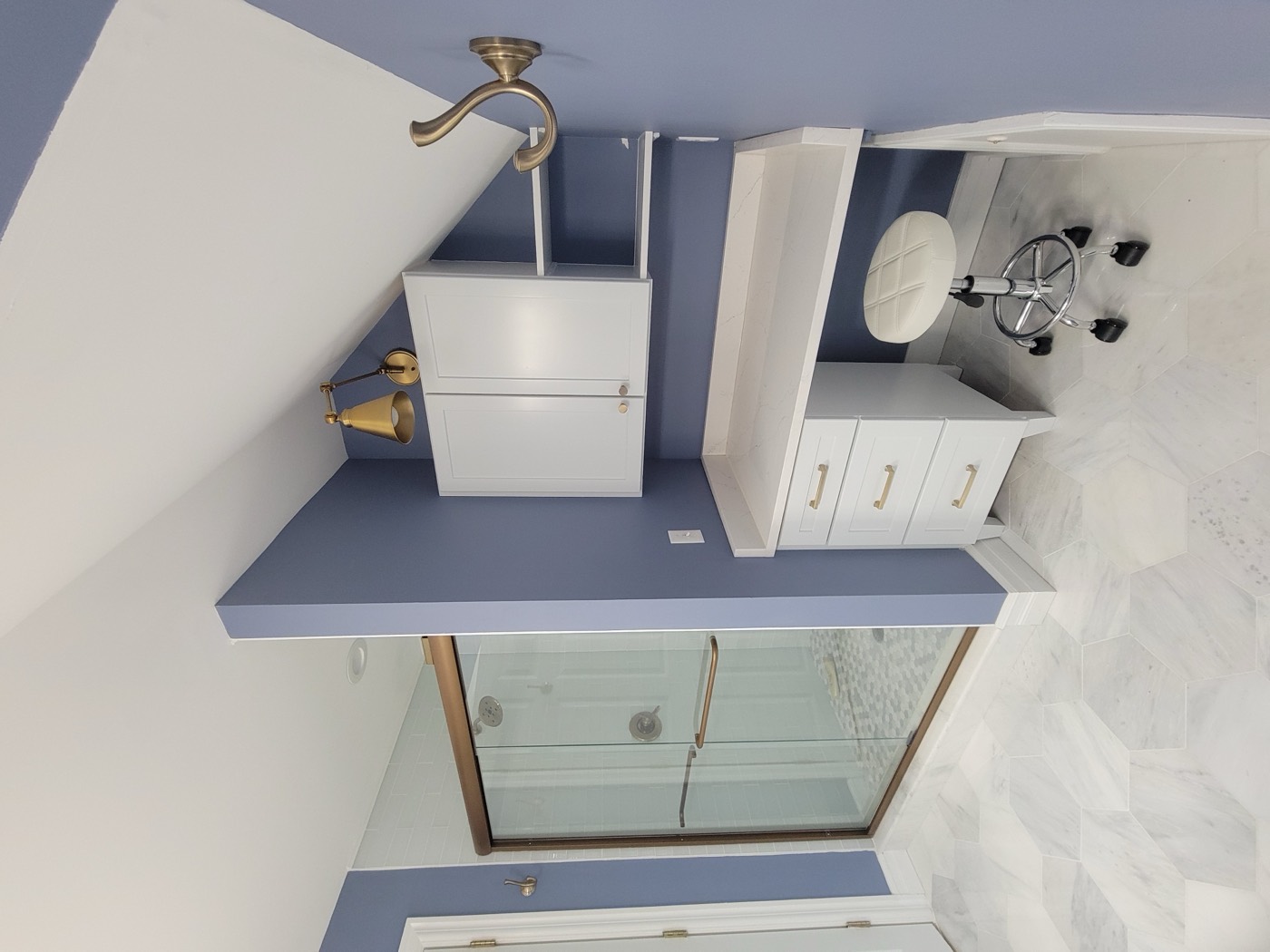 Attic bathroom with periwinkle walls and built-in vanity desk