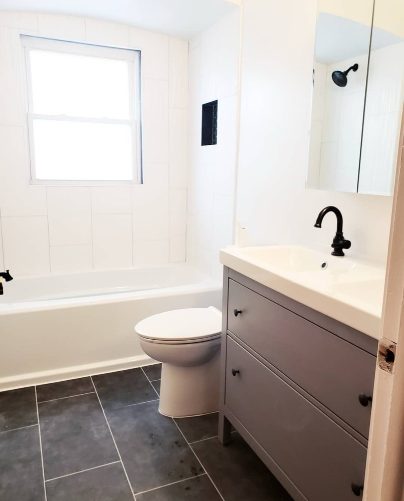 Bathroom with slate tile floor and gray vanity