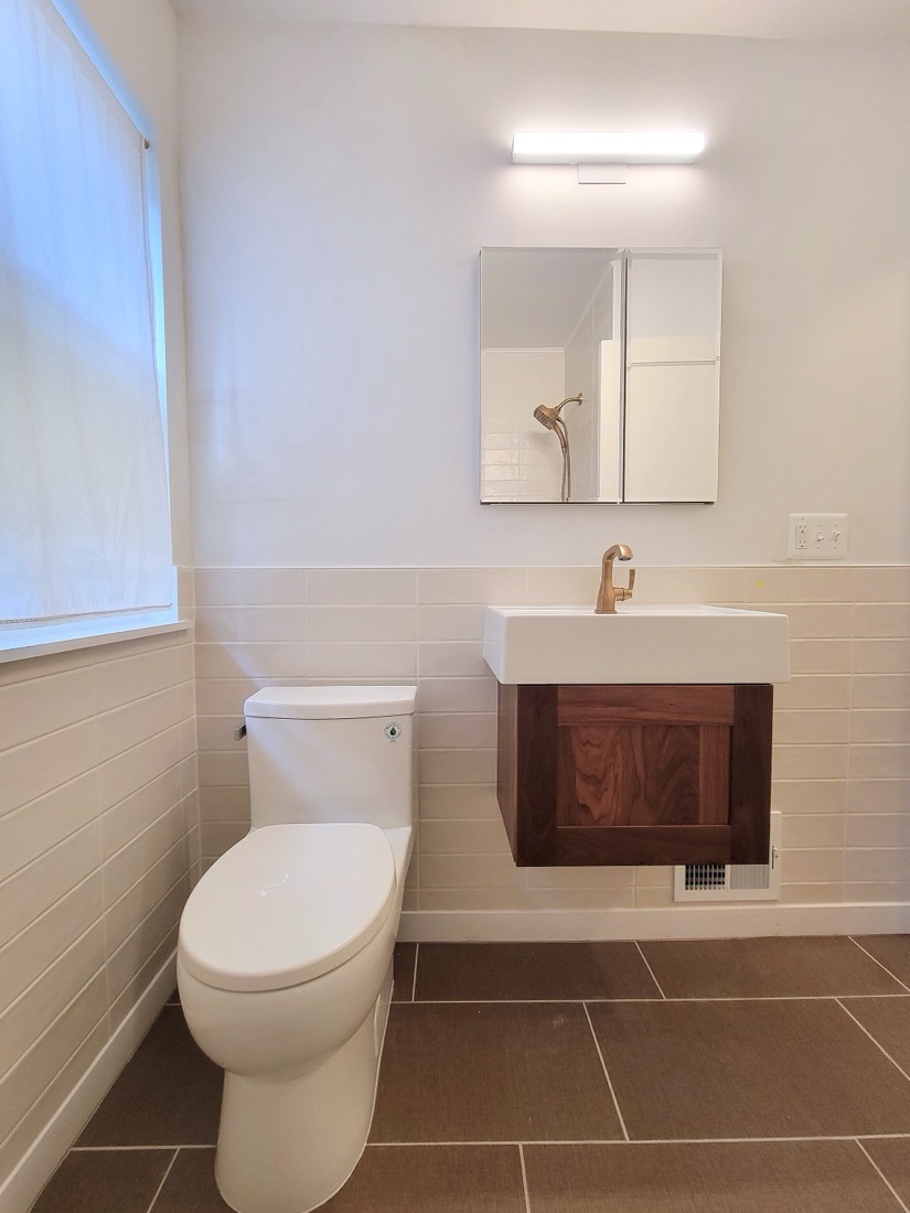 Mid-century bathroom with floating walnut vanity