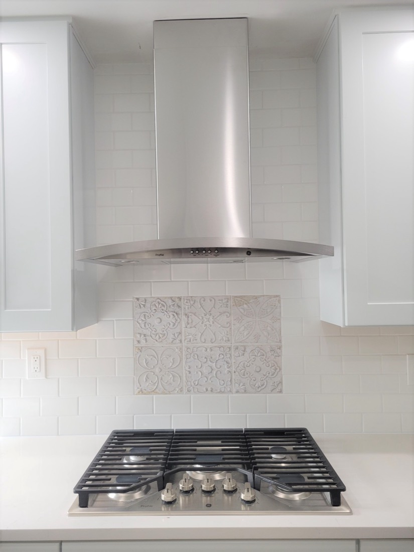 Stainless range hood and gas cooktop detail
