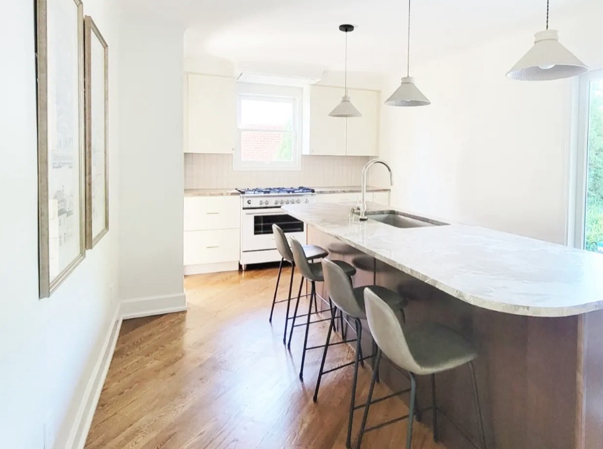 Long kitchen island with three pendants