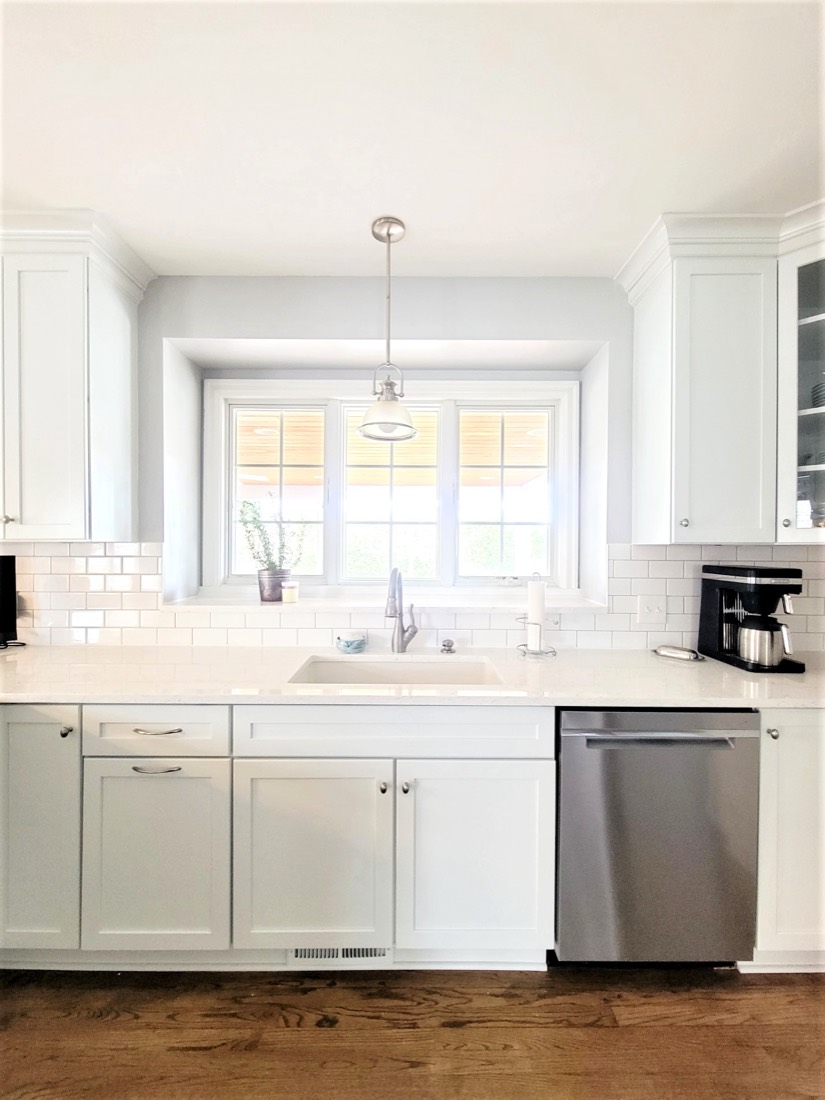 Bright white kitchen with subway tile and farmhouse sink